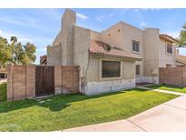 Inviting exterior showcasing a well-maintained lawn and neutral-toned stucco facade, enhancing curb appeal at 222 W Brown Rd # 57, Mesa, AZ 85201