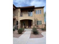 Inviting two-story home featuring a private balcony, decorative stone accents, and a well-manicured front yard at 2821 S Skyline Dr # 149, Mesa, AZ 85212