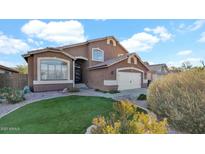 Beautiful home with a well-manicured lawn and desert landscaping, set against a backdrop of clear blue skies and fluffy white clouds at 3119 E Rosemonte Dr, Phoenix, AZ 85050