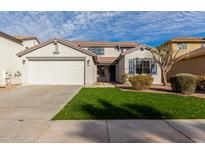 Charming two-story home featuring a well-manicured lawn and a two-car garage, exuding curb appeal at 32815 N Slate Creek Dr, San Tan Valley, AZ 85143