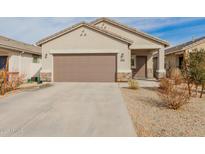 Charming single-story home with a two-car garage, neutral stucco, and low-maintenance desert landscaping at 35374 W San Sisto Ave, Maricopa, AZ 85138