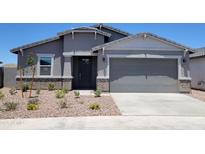 Charming single-story home with neutral stucco, brick accents, and a well-kept xeriscaped front yard at 3850 N Camden Dr, Florence, AZ 85132
