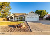 Charming single-Gathering home featuring a well-manicured lawn and a spacious driveway at 3957 E Adobe St, Mesa, AZ 85205