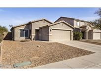 Charming single-Gathering home featuring a two-car garage and low-maintenance desert landscaping at 43556 W Colby Dr, Maricopa, AZ 85138