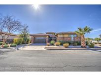 Beautiful single-story home showcasing a well-manicured yard and a two-car garage at 4750 S Rhodium Ln, Mesa, AZ 85212