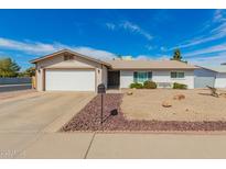 Charming single-story home with a well-maintained front yard and attached two-car garage at 5256 W Port Au Prince Ln, Glendale, AZ 85306