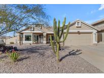 Charming single-story home with desert landscaping and two-car garage at 5940 E Taunus Cir, Mesa, AZ 85215