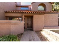 Inviting townhome front entrance features a tiled roof and a private walkway to the front door at 609 E Mesquite Cir # D131, Tempe, AZ 85288