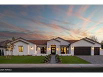 Inviting exterior view of a home with a well-manicured lawn, beautiful desert landscaping, and a paver driveway at 6312 E Calle Del Paisano --, Scottsdale, AZ 85251