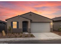 Charming single-story home with a two-car garage and well-maintained landscaping in a vibrant community at 8555 W Trenton Ct, Florence, AZ 85132