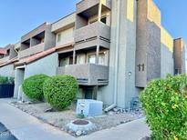 Three-story condo unit showcasing balconies, desert landscaping, and modern architectural design at 1645 W Baseline Rd # 2050, Mesa, AZ 85202