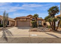 Charming single-story home featuring desert landscaping, a tile roof, and a two-car garage at 16808 N 59Th Pl, Scottsdale, AZ 85254