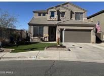 Charming two-story home featuring a desert landscape, covered entry, two-car garage, and quaint front porch at 17012 S 27Th Ln, Phoenix, AZ 85045