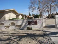 Exterior view of the Tara Court entrance sign surrounded by well-maintained landscaping at 17019 N Pinion Ln, Sun City, AZ 85373