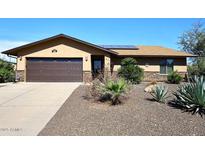 Charming single-story home with desert landscaping, stone accents, and a two-car garage at 1920 E Manzanita Dr, Phoenix, AZ 85020