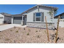 Charming single-story home with neutral stucco, stone accents, gray shutters, and well-maintained desert landscaping at 3764 N Camden Dr, Florence, AZ 85132