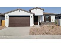 Charming single-story home featuring a two-car garage and desert landscaping in front at 3782 N Camden Dr, Florence, AZ 85132