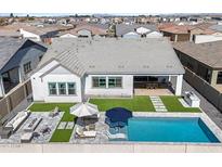 Stunning aerial view of a modern home featuring a pool, outdoor kitchen, and lush landscaping at 4097 E Tonto Pl, Chandler, AZ 85249