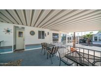 Relaxing covered patio with sun decor, seating, and outdoor charm at 624 Hawk Eye Dr, Apache Junction, AZ 85119