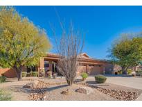 Charming desert home with low maintenance landscaping and a three car garage at 7138 W Buckskin Trl, Peoria, AZ 85383