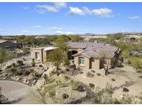 An elevated view of a desert home with a tile roof and drought-resistant landscaping at 7848 E Parkview Ln, Scottsdale, AZ 85255