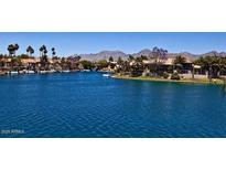 Scenic waterfront view featuring calm water, waterfront homes and a mountain backdrop at 10080 E Mountain View Lake Dr # 138, Scottsdale, AZ 85258