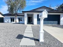 Charming single-story home featuring a well-manicured yard and modern design elements at 10815 N 65Th Ave, Glendale, AZ 85304