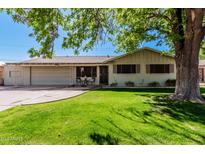 Charming single-story home with a well-manicured lawn and mature trees, set in a desirable neighborhood at 1649 E Dana Ave, Mesa, AZ 85204