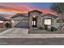Charming home exterior featuring stone accents, desert landscaping, and a two-car garage at 18508 W Galveston St, Goodyear, AZ 85338