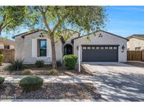 Charming single-story home featuring a two-car garage and desert landscaping at 20159 E Rosa Rd, Queen Creek, AZ 85142