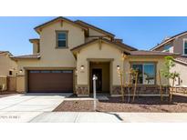 Inviting two-story home featuring a two-car garage, neutral colors, and tasteful stone accents at 20951 E Via Del Sol St, Queen Creek, AZ 85142