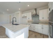 Bright kitchen featuring a large island with a waterfall countertop and stainless steel appliances at 2121 W Sonoran Desert Dr # 13, Phoenix, AZ 85085