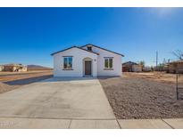 Charming single-story home featuring a crisp white exterior and desert landscaping at 245 E Date Ave, Casa Grande, AZ 85122