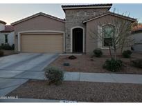 Charming single-story home featuring a stone facade, arched entry, and a two-car garage at 2541 E San Ricardo Trl, Casa Grande, AZ 85194
