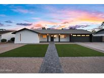 Charming single-story home featuring a well-manicured lawn and a two-car garage at 2901 E Cortez St, Phoenix, AZ 85028