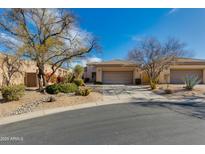 Charming single-story home featuring desert landscaping, a tile roof and a three-car garage at 34435 N 68Th Way, Scottsdale, AZ 85262