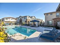 Relaxing community pool area with lounge chairs, a gazebo, and a sparkling pool at 4100 S Pinelake Way # 143, Chandler, AZ 85249