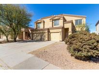 Charming two-story home featuring a three car garage and low-maintenance desert landscaping at 43608 W Kristal Ln, Maricopa, AZ 85138