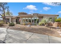 Beautiful Southwestern home with desert landscaping, neutral tones and eye-catching architectural details at 7370 E Sunset Sky Cir, Scottsdale, AZ 85266