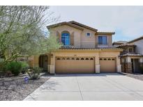 Charming two-story home with a three-car garage, well-manicured landscaping, and a neutral color palette at 9901 E Bahia Dr, Scottsdale, AZ 85260