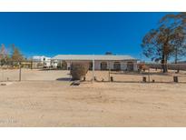 Property featuring a fence and desert landscaping under a bright blue sky at 1015 N 193Rd Ave, Buckeye, AZ 85326