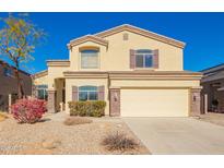 Inviting two-story home featuring a neutral color scheme, manicured landscaping, and an attached two-car garage at 1244 W Castle Dr, Casa Grande, AZ 85122