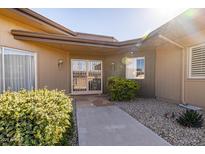 Inviting front entrance with security gate, desert landscaping, and a walkway to the front door at 13623 N 108Th Dr, Sun City, AZ 85351