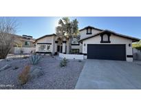 Charming home with a low-maintenance desert landscape, a desert palm, and a two car garage at 14820 N 44Th Pl, Phoenix, AZ 85032