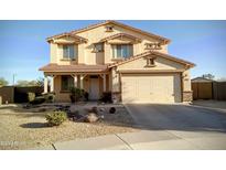 Charming two-story home featuring a two-car garage and a well-maintained, xeriscaped front yard at 17263 W Fetlock Trl, Surprise, AZ 85387