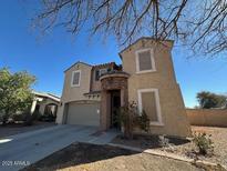 Charming two-story home with a well-maintained front yard and neutral-toned exterior at 17345 N Costa Brava Ave, Maricopa, AZ 85139