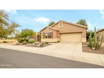 Charming single-story home featuring a desert landscaped front yard and two car garage at 17553 N Thornberry Dr, Surprise, AZ 85374