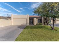 Charming single-story home with a well-maintained front yard and an attached two-car garage at 2212 W Claremont St, Phoenix, AZ 85015