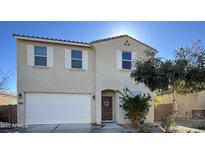 Two-story home with a neutral stucco finish, a two-car garage and a well-kept front yard at 23689 W Watkins St, Buckeye, AZ 85326