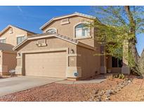 Charming two-story home featuring a tan exterior, desert landscaping, and attached two-car garage at 28549 N Dolomite Ln, San Tan Valley, AZ 85143